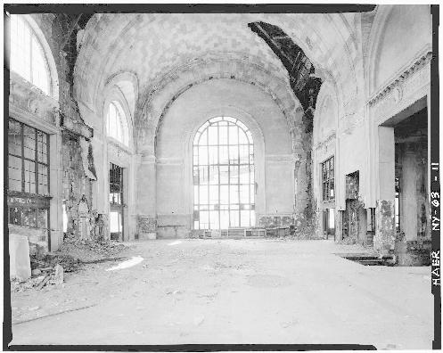 Interior of larger DL&W passenger building showing main concourse on upper level, with stairway from street level at right of photo and passage to trains at left. Skyway can be seen through large window facing Buffalo River. Matching window is directly opposite.