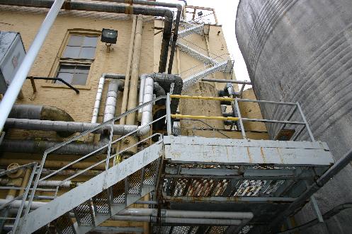 Outside the brewhouse. To the right is one of the brewery's large outdoor storage tanks