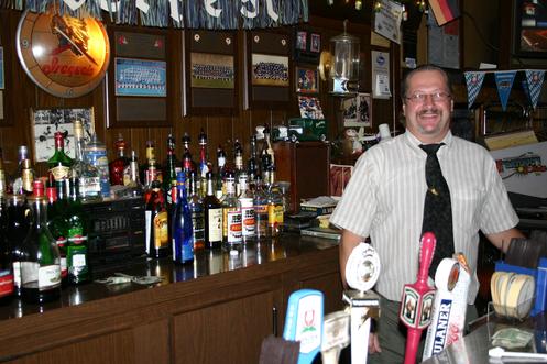 Jerry Scharf serves up a pint! Tucked away in one of Buffalos oldest German neighborhoods near Schiller Park, this charming restaurant serves the Vaterland's most widely known dishes. The wienerschnitzel, sauerbraten, and rouladen rival those of any modest old-world restaurant. The lunch and dinner menus also list Limburger sandwiches, bratwurst and a wide selection of American entrées, but go in search of the classics. Frau Scharf and family do not disappoint. All entrées are served with a choice of knödl (dumpling), spätzle (thick German egg noodles) or potato, including hot potato pancakes served with applesauce and sour cream. Be sure to try a Hefe Weisse or another of the specialty beers on the menu to help transport you and your taste buds thousands of miles away. Scharfs has been a fixture in Buffalo since 1967, offering fine and authentic German cooking. Founder Margaret Scharfs family once owned the famous Trodils Restaurant on Olympic Street.  Scharf left Germany shortly after World War II.